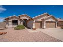 Charming single-story home with a tile roof, two-car garage, and low-maintenance desert landscaping at 6988 W Monte Lindo --, Glendale, AZ 85310