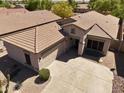 An aerial view of a well-maintained single-Gathering home with a tile roof and desert landscaping at 7111 S 21St Dr, Phoenix, AZ 85041