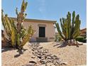 Desert landscape design using rock lined dry creek bed with native plants and cacti at 7111 S 21St Dr, Phoenix, AZ 85041