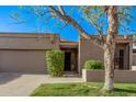 Charming single-level home featuring a two-car garage and beautifully landscaped front yard at 7962 E San Miguel Ave, Scottsdale, AZ 85250