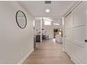 Inviting hallway featuring wood flooring, a modern mirror, and access to the living spaces at 7962 E San Miguel Ave, Scottsdale, AZ 85250