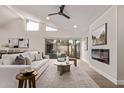 Bright living room featuring vaulted ceilings, fireplace, and sliding glass doors to the backyard at 7962 E San Miguel Ave, Scottsdale, AZ 85250