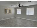 Open living room featuring tile flooring, neutral paint and natural light from two windows at 845 N Los Alamos Dr, Goodyear, AZ 85338