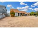 Single-story home with a carport, neutral paint, minimal landscaping, and a concrete driveway at 9028 W Osborn Rd, Phoenix, AZ 85037