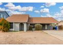 Charming single-story home with a carport, neutral paint, and low-maintenance landscaping at 9028 W Osborn Rd, Phoenix, AZ 85037