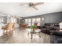 Bright and open living space featuring wood-look flooring, modern furnishings, and a seamless kitchen view at 9333 E University Dr # 83, Mesa, AZ 85207