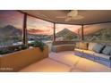 A covered patio with built-in seating and scenic mountain views at 11334 E Troon Vista Dr, Scottsdale, AZ 85255