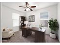 Bright office space with desk, chair, ceiling fan, bookcase and plants at 134 E Bernie Ln, Gilbert, AZ 85295