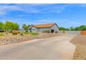 Attractive desert landscaping frames this home with a large, extended driveway at 14415 N 184Th Ave, Surprise, AZ 85388
