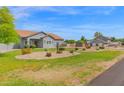 Expansive lawn complements the front exterior of this attractive, single-story residential property at 14415 N 184Th Ave, Surprise, AZ 85388