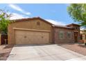 Single story home with a neutral color scheme, two car garage and low maintenance front yard at 16987 W Hammond St, Goodyear, AZ 85338