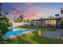 Inviting backyard oasis with a sparkling pool, covered patio, perfect for relaxing and entertaining at 1702 W Glenrosa Ave, Phoenix, AZ 85015