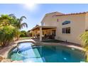 Beautiful backyard pool with well manicured lawn and covered patio area at 1737 E Primera Dr, Casa Grande, AZ 85122