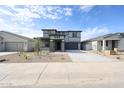 Inviting two-story home with a spacious driveway and desert landscaping at 17977 W Camino De Oro Riv, Surprise, AZ 85387