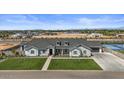 Beautiful single-Gathering home boasting manicured lawn, stone accents, and a three-car garage in a well-planned community at 18826 E Augusta Ave, Queen Creek, AZ 85142