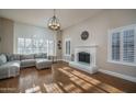 Bright living room with a fireplace, wood floors, and neutral decor at 19115 N 71St Dr, Glendale, AZ 85308