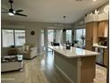 Open kitchen flows into living area and features large island and lots of natural light at 20298 N 108Th Ln, Sun City, AZ 85373
