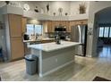 Bright kitchen features a center island, stainless steel appliances and lots of natural light at 20298 N 108Th Ln, Sun City, AZ 85373