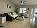 Cozy living room with plush sofa, decorative pillows, and a charming decor at 20298 N 108Th Ln, Sun City, AZ 85373