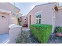 Inviting entrance featuring a cozy seating area and lush, trimmed greenery by the front door at 20581 N Enchantment Pass, Maricopa, AZ 85138