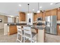 Eat-in kitchen featuring stainless steel appliances, granite countertops, and custom cabinetry at 2189 W Mila Way, San Tan Valley, AZ 85144
