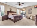 Cozy main bedroom with sliding door access to the backyard and neutral carpeting at 2189 W Mila Way, San Tan Valley, AZ 85144