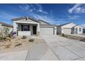 Charming single-story home featuring a two-car garage and low maintenance desert landscaping at 22045 N Rummler Ln, Maricopa, AZ 85138