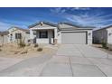 Charming single-story home featuring a two-car garage and low maintenance desert landscaping at 22045 N Rummler Ln, Maricopa, AZ 85138