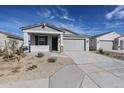 Charming single-story home featuring a two-car garage and low maintenance desert landscaping at 22045 N Rummler Ln, Maricopa, AZ 85138