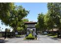 Elegant gated community entrance with manicured landscaping, providing privacy and security for residents at 2322 S Rogers -- # 1, Mesa, AZ 85202