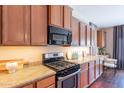 Modern kitchen with stainless steel appliances, granite countertops, and ample cabinet space at 2323 W Kachina Trl, Phoenix, AZ 85041