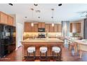 Beautiful kitchen boasts a large island, wood cabinetry, and stainless steel appliances at 2323 W Kachina Trl, Phoenix, AZ 85041