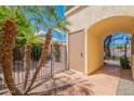Cozy gated courtyard with terra cotta tile, mature palms, and secure entry to home at 2369 W Shawnee Dr, Chandler, AZ 85224