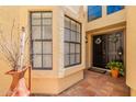 Welcoming front entry featuring a dark front door, tile walkway, and decorative plants at 2369 W Shawnee Dr, Chandler, AZ 85224