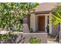 Inviting front entrance with a beautiful wooden door and textured columns at 2633 S El Dorado Dr, Mesa, AZ 85202