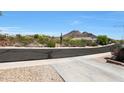 Scenic view of the neighborhood street with desert landscaping and mountain backdrop at 26814 N 65Th Dr, Phoenix, AZ 85083