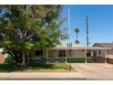 Quaint single-story home with a well-maintained front yard and mature trees, a cozy covered porch at 2926 W San Miguel Ave, Phoenix, AZ 85017
