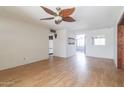 Bright living room featuring hardwood floors, a ceiling fan, and neutral walls, offering great potential at 2926 W San Miguel Ave, Phoenix, AZ 85017