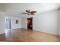Spacious living room with hardwood floors and a decorative ceiling fan, ready for personalization at 2926 W San Miguel Ave, Phoenix, AZ 85017