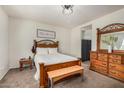 Cozy bedroom featuring carpeted floors and natural wood furniture at 30238 N Ocotillo Dr, Florence, AZ 85132