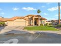 Charming single-story home featuring a three-car garage, desert landscaping, and a tile roof at 3295 S Ambrosia Dr, Chandler, AZ 85248