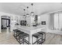Bright kitchen with a large island, breakfast bar, and modern pendant lighting at 3535 W Morgan Ln, San Tan Valley, AZ 85144