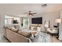 Bright living room with a large sectional sofa and an open view to the kitchen at 3555 E Morenci Rd, San Tan Valley, AZ 85143