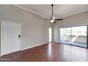 Bright living room featuring wood floors, ceiling fan, and sliding glass doors at 3600 N Hayden Rd # 3002, Scottsdale, AZ 85251