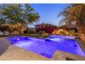 Lush backyard with a private pool, spa, and colorful desert landscaping at 3641 E Los Gatos Dr, Phoenix, AZ 85050