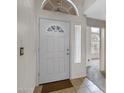 Interior view of the front door with decorative window, neutral paint, and tile flooring at 3711 E Long Lake Rd, Phoenix, AZ 85048