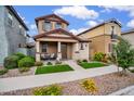 Inviting two-story home with a charming front porch, complemented by well-maintained landscaping and vibrant flowers at 4156 E Jesse St, Gilbert, AZ 85295