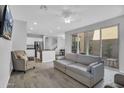 Bright, open-concept living room with modern furniture, ceiling fan, and sliding glass doors for natural light at 4156 E Jesse St, Gilbert, AZ 85295