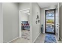 Bright entryway with tile flooring and view into the bedroom at 41769 W Canasta Ln, Maricopa, AZ 85138