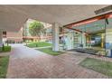 Inviting entrance to building with a lush courtyard, brick walkway, and glass entryway at 4808 N 24Th St # 1003, Phoenix, AZ 85016